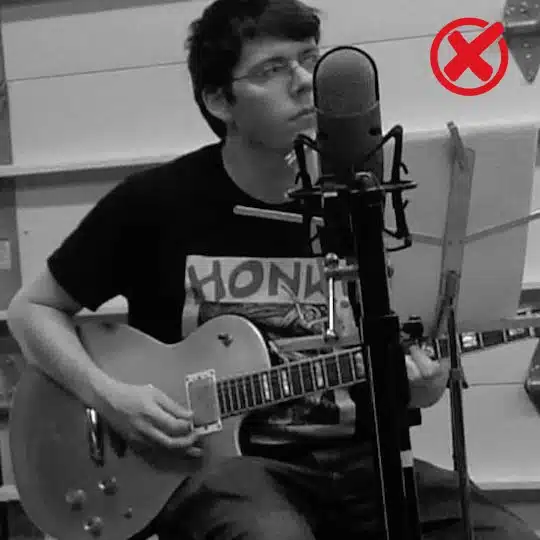 example of a bad music teacher picture, where the teacher has distracting music gear and is not looking at the camera.