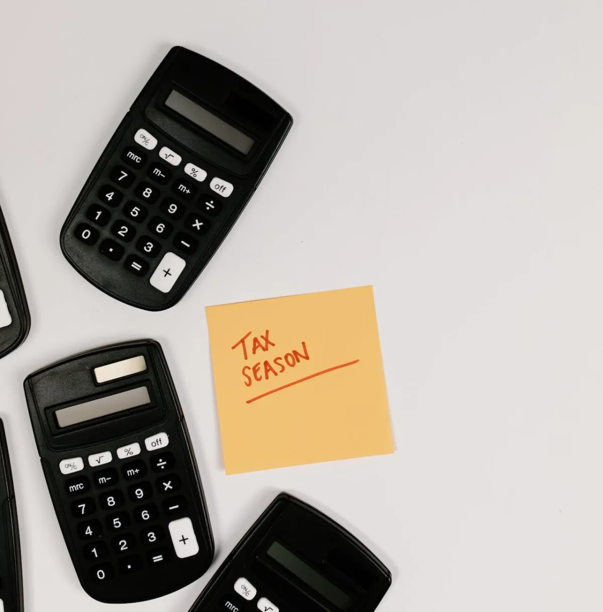 calculator and a post it saying tax season