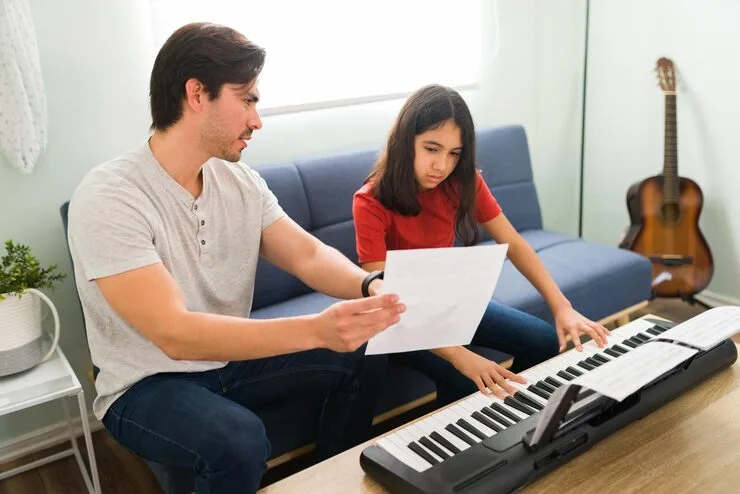 Music teacher helping a student