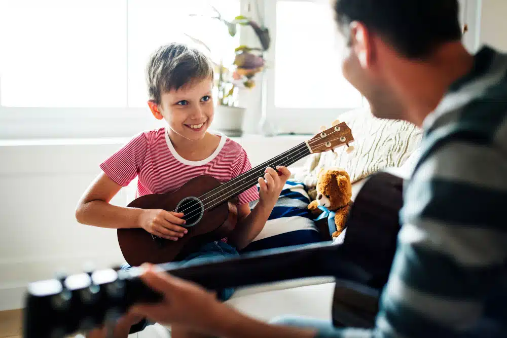 Young boy playing ukulele